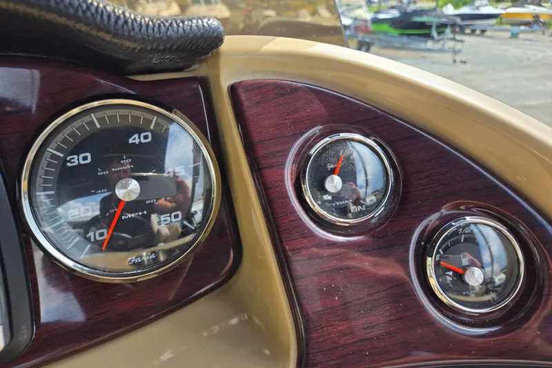 Slide: The Image of Dashboard of a 2013 Sanpan 2500 FE boat with speedometer and gauges. - 33