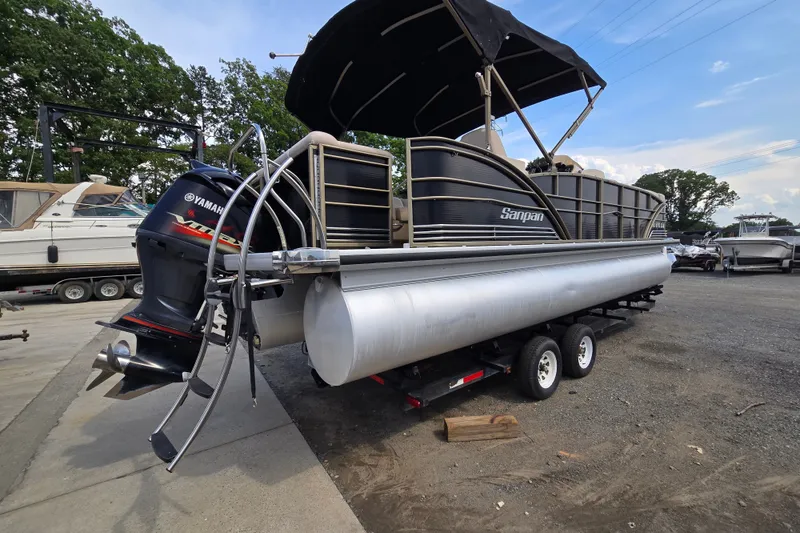 Slide: The Image of 2013 Sanpan 2500 FE pontoon boat with Yamaha engine on trailer. - 1