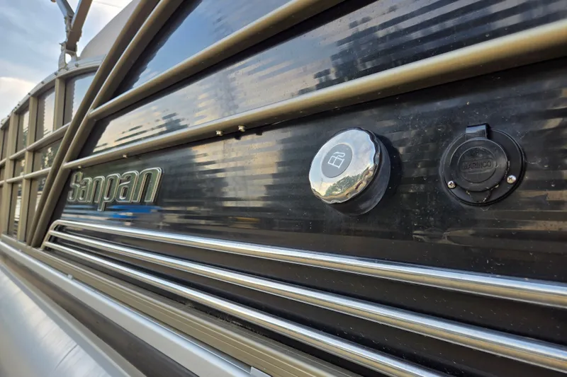 Slide: The Image of Close-up of a 2013 Sanpan 2500 FE boat exterior with fuel cap and logo. - 6
