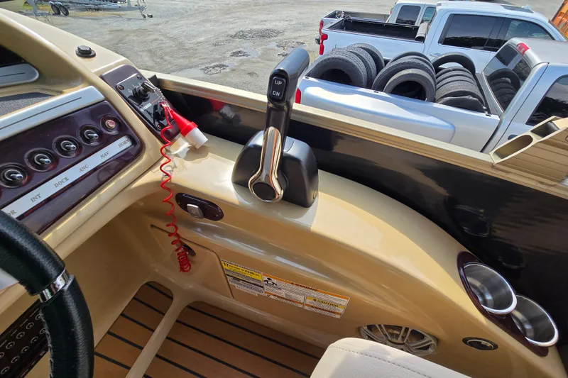 Slide: The Image of Interior view of a 2013 Sanpan 2500 FE boat dashboard with controls and throttle. - 37