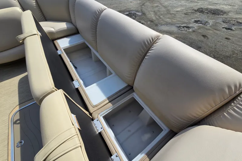 Slide: The Image of 2013 Sanpan 2500 FE boat with open storage compartments and beige seating. - 25