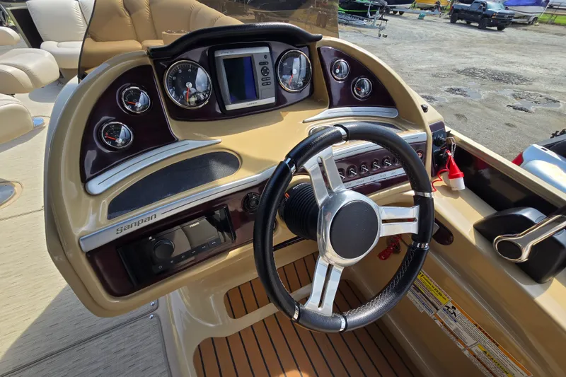 Slide: The Image of Steering console of 2013 Sanpan 2500 FE boat with gauges and controls. - 29