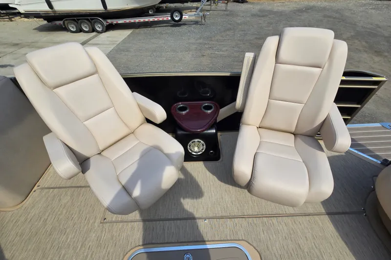 Slide: The Image of Two beige captain chairs on a 2013 Sanpan 2500 FE boat deck. - 16