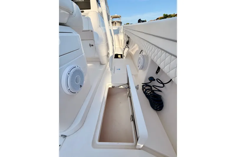 Slide: The Image of 2016 Intrepid 375 Center Console boat interior with storage compartment and speakers. - 15
