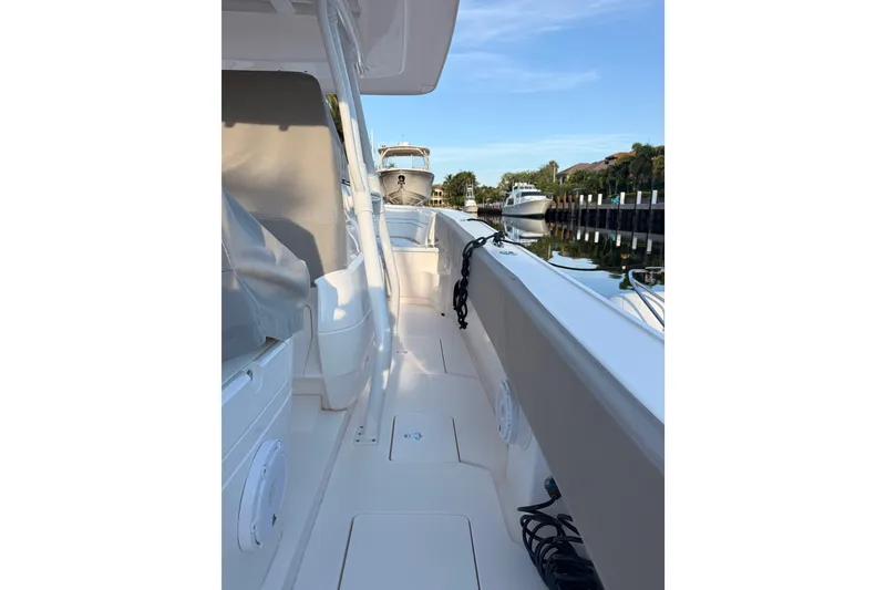 Slide: The Image of 2016 Intrepid 375 Center Console boat docked on a calm waterway. - 5