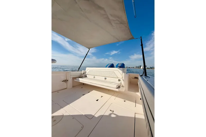 Slide: The Image of 2016 Intrepid 375 Center Console boat with canopy, ocean view, and seating area. - 55