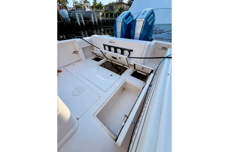 Slide: The Image of 2016 Intrepid 375 Center Console boat with open storage compartments and dual engines. - 19