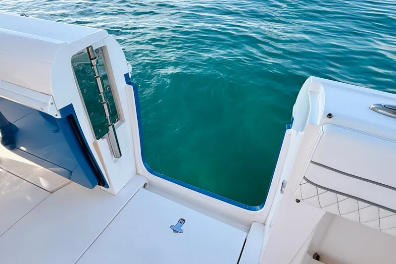 Slide: The Image of 2016 Intrepid 375 Center Console boat with open side door, overlooking clear blue water. - 73