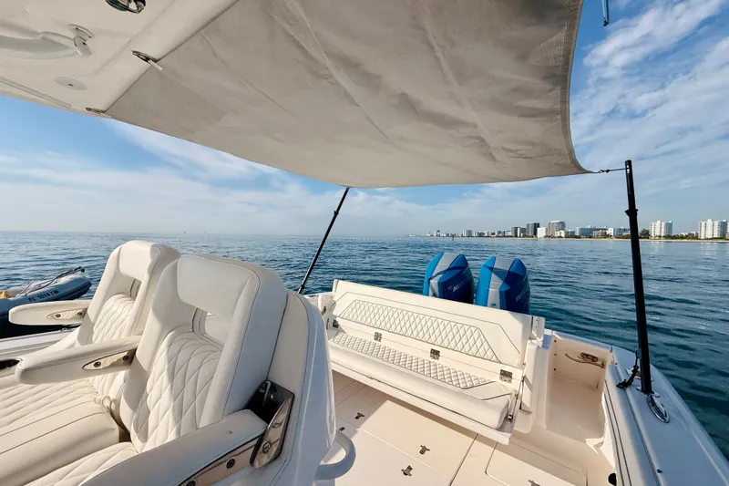 Slide: The Image of 2016 Intrepid 375 Center Console boat with seating, ocean view, and city skyline. - 54