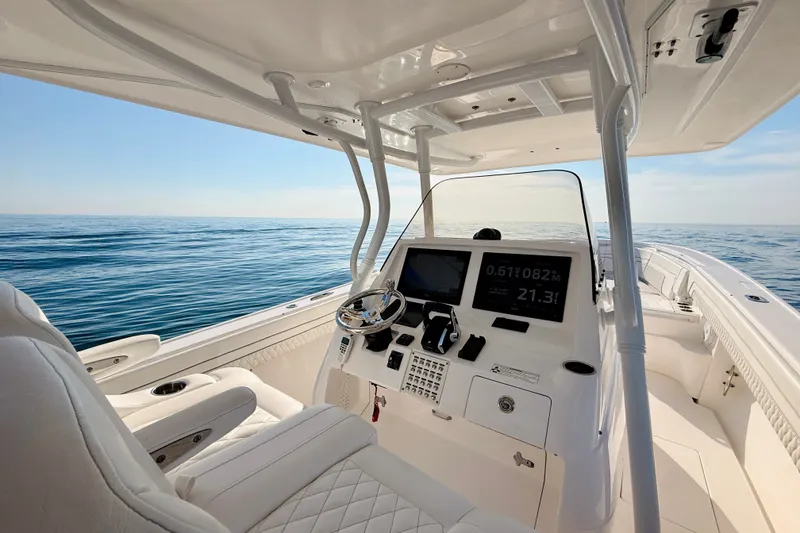 Slide: The Image of 2016 Intrepid 375 Center Console boat interior with ocean view and modern dashboard. - 64