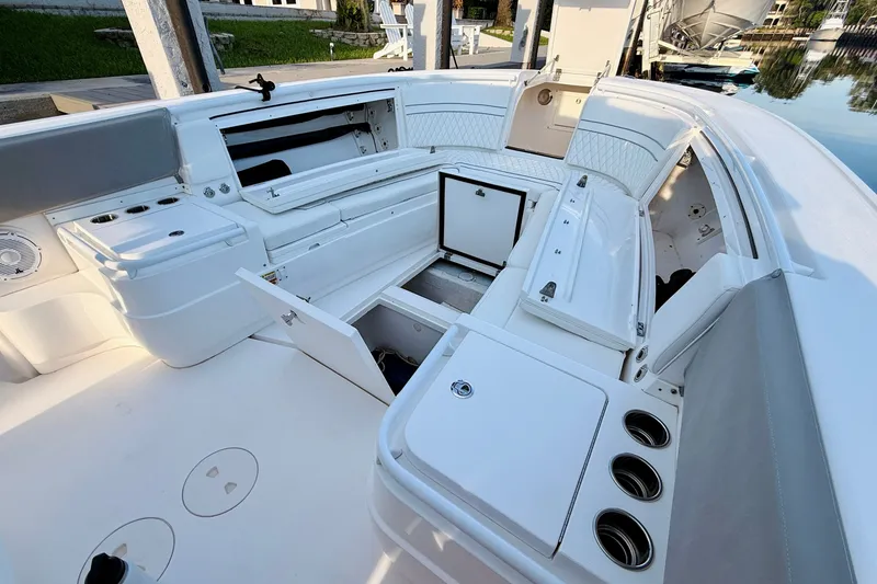 Slide: The Image of 2016 Intrepid 375 Center Console boat interior with open storage compartments and seating. - 8