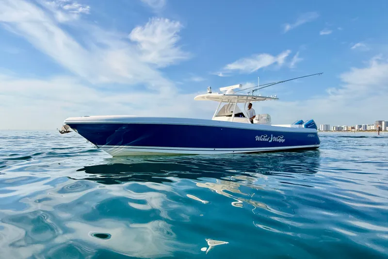 Slide: The Image of 2016 Intrepid 375 Center Console boat on calm ocean waters under blue sky. - 46