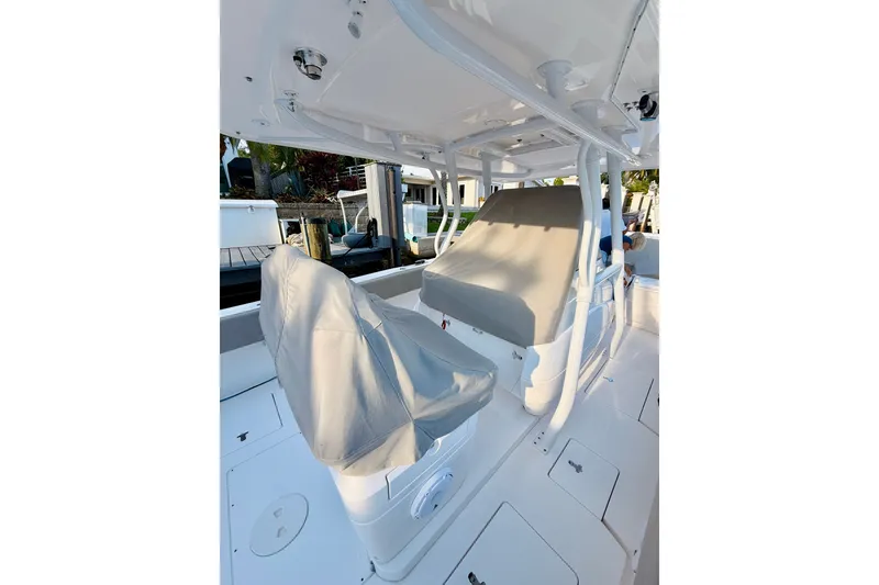Slide: The Image of 2016 Intrepid 375 Center Console boat interior with covered seating and white deck. - 3