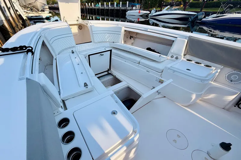 Slide: The Image of 2016 Intrepid 375 Center Console boat interior with open storage compartments and seating. - 7