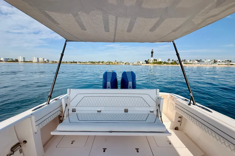 Slide: The Image of 2016 Intrepid 375 Center Console boat with scenic coastal view and lighthouse. - 58