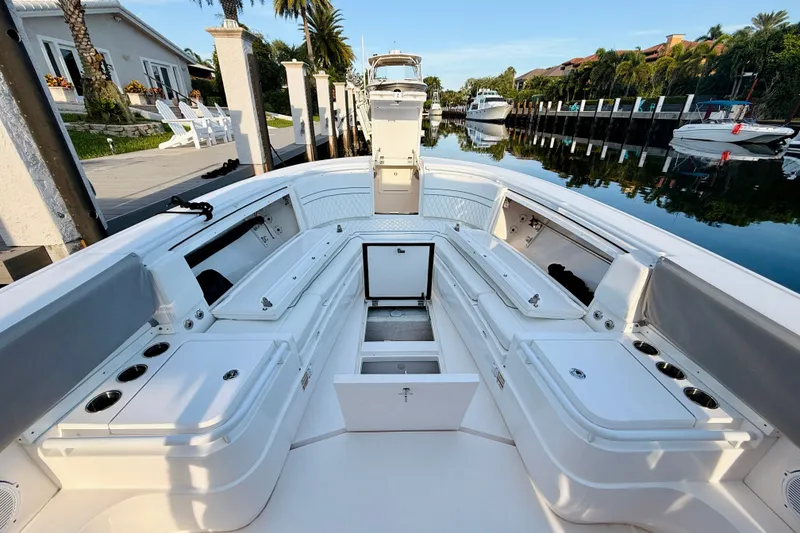 Slide: The Image of 2016 Intrepid 375 Center Console boat docked in a scenic canal setting. - 6