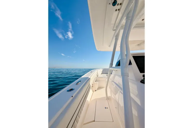 Slide: The Image of 2016 Intrepid 375 Center Console boat on calm ocean waters under clear blue sky. - 48