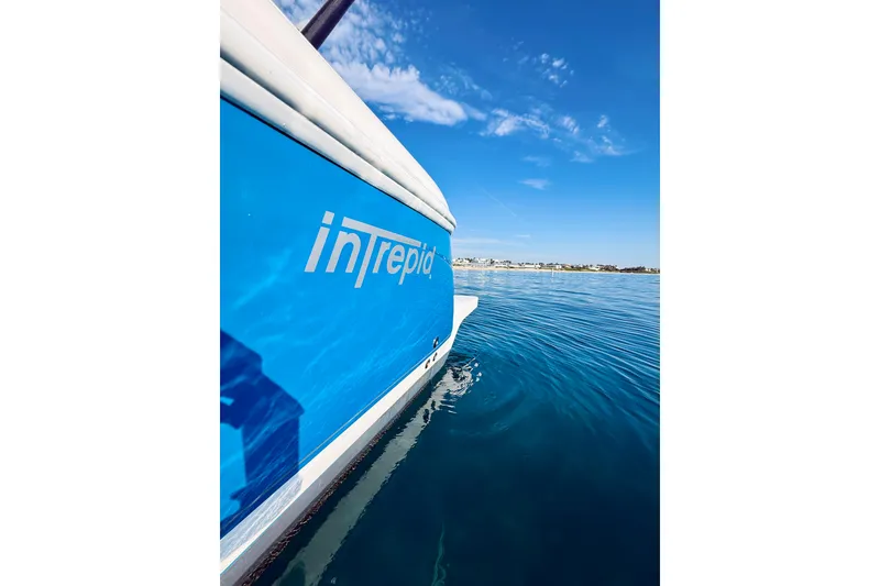 Slide: The Image of 2016 Intrepid 375 Center Console boat on calm blue water under clear sky. - 77