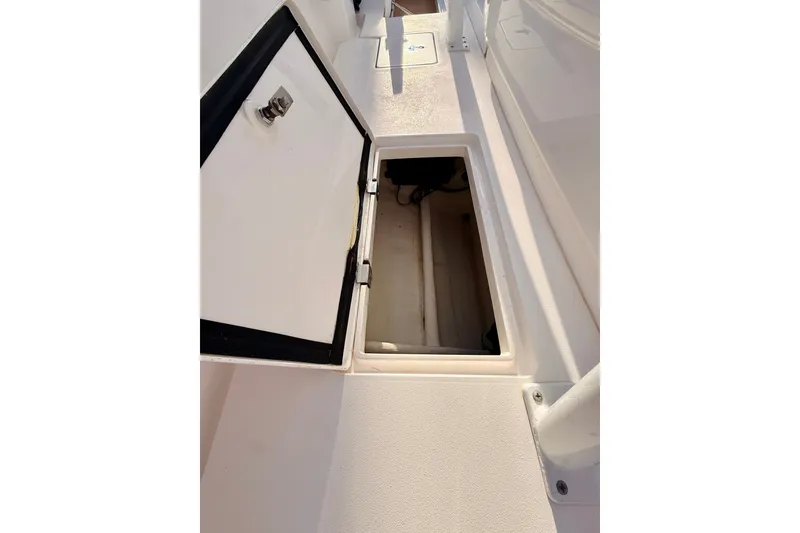 Slide: The Image of Open storage compartment on 2016 Intrepid 375 Center Console boat deck. - 18