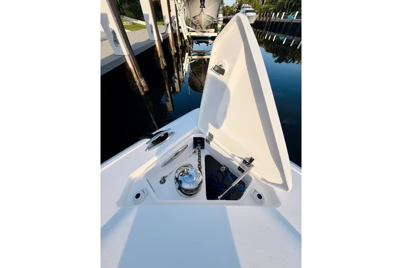Slide: The Image of Open anchor compartment on 2016 Intrepid 375 Center Console boat at dock. - 10