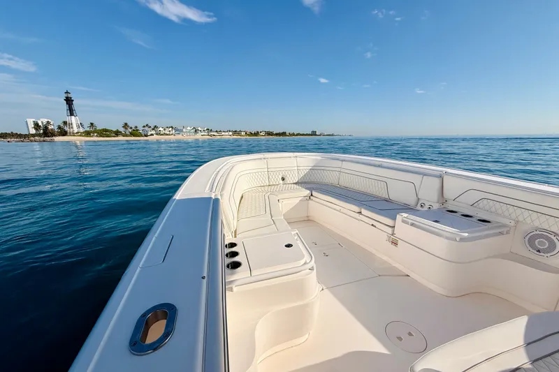 Slide: The Image of 2016 Intrepid 375 Center Console boat on calm ocean near lighthouse. - 49