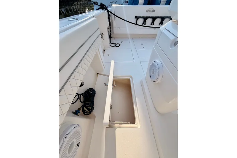 Slide: The Image of 2016 Intrepid 375 Center Console boat interior with storage compartment and speakers. - 17