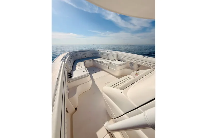 Slide: The Image of 2016 Intrepid 375 Center Console boat interior with ocean view, featuring spacious seating. - 50