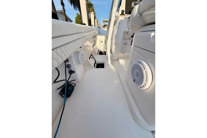 Slide: The Image of 2016 Intrepid 375 Center Console boat interior with speakers and storage compartments. - 16