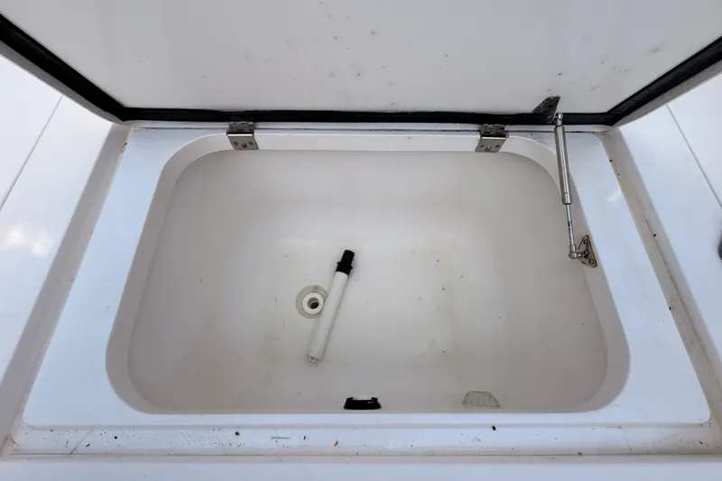 Slide: The Image of Open storage compartment on 2016 Intrepid 375 Center Console boat. - 21