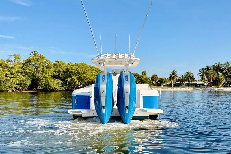 Slide: The Image of 2016 Intrepid 375 Center Console boat with twin 400 engines on calm water. - 28