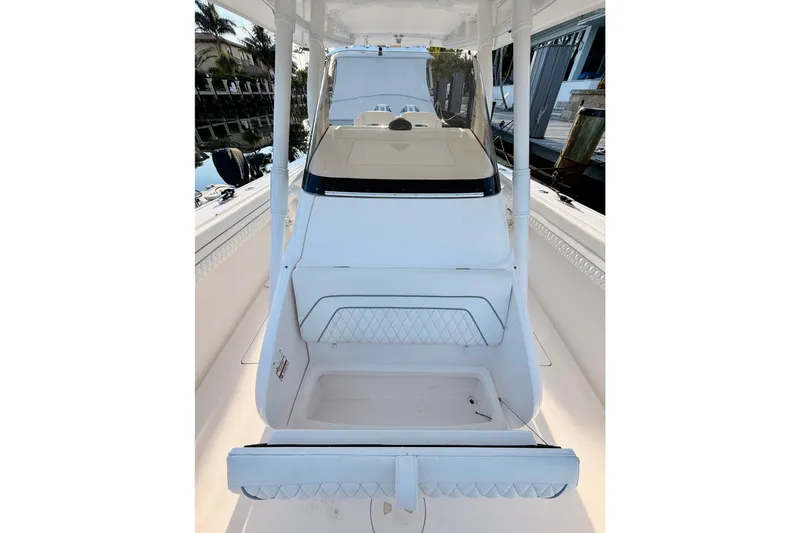 Slide: The Image of 2016 Intrepid 375 Center Console boat interior, featuring sleek white design and seating area. - 12