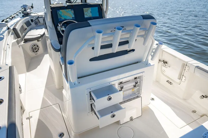 Slide: The Image of Manufacturer Provided Image: 2026 Cobia 245 Center Console boat interior with rod holders and storage drawers. - 12