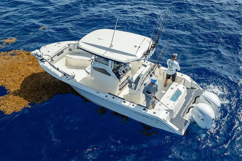 Slide: The Image of Manufacturer Provided Image: 2026 Cobia 245 Center Console boat with anglers on blue ocean waters. - 1