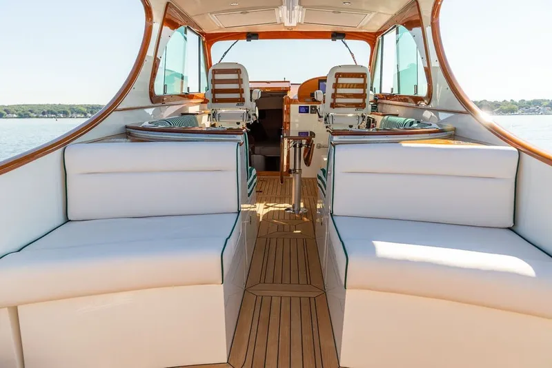 Slide: The Image of Luxurious interior of 2023 Hinckley 35 yacht with elegant seating and wooden accents. - 23