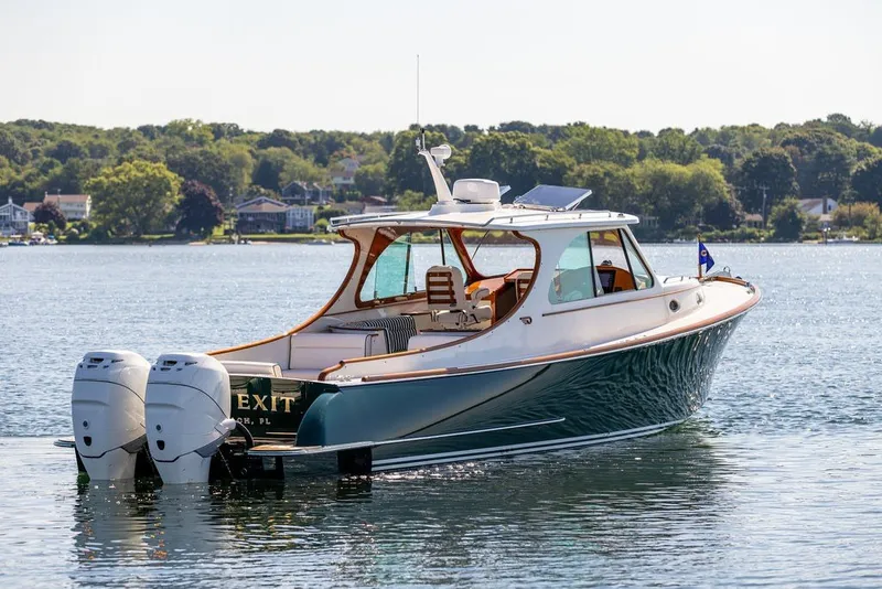 Slide: The Image of 2023 Hinckley 35 boat on calm water, featuring dual outboard engines. - 13