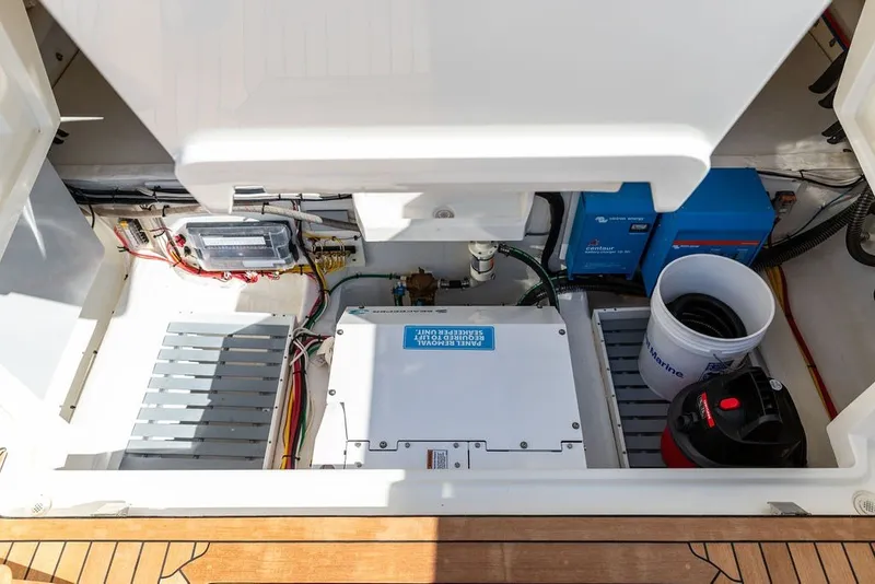 Slide: The Image of Engine compartment of 2023 Hinckley 35 boat, showcasing electrical components and storage. - 34