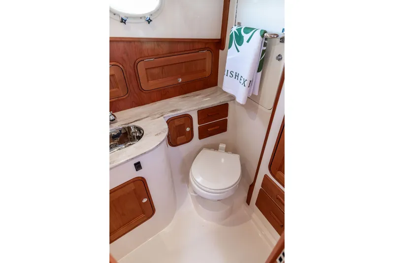 Slide: The Image of Luxurious 2023 Hinckley 35 yacht bathroom with wood accents and modern fixtures. - 31