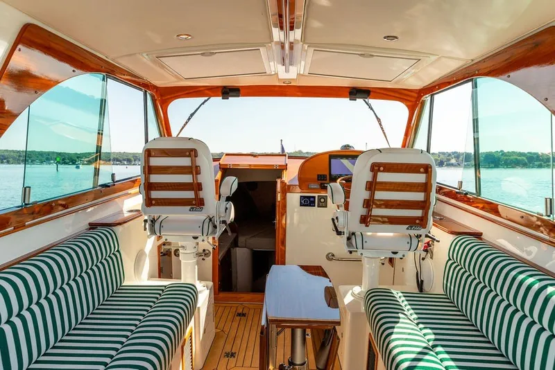 Slide: The Image of Interior of 2023 Hinckley 35 yacht with striped seating and wooden accents. - 16