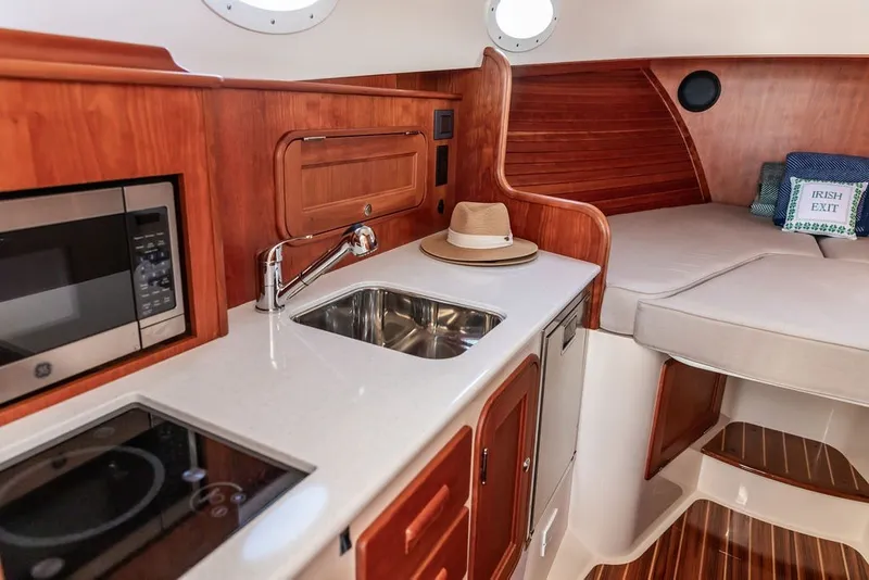 Slide: The Image of Luxurious interior of 2023 Hinckley 35 yacht with kitchenette and cozy seating area. - 27