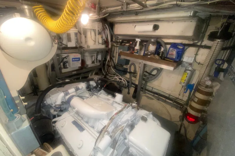 Slide: The Image of Engine room of a 1983 Hatteras 53 Motor Yacht, showcasing machinery and maintenance tools. - 44
