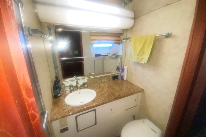 Slide: The Image of Bathroom interior of 1983 Hatteras 53 Motor Yacht with sink, mirror, and towel rack. - 39