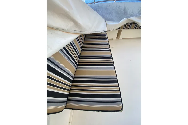 Slide: The Image of Striped seating on 1983 Hatteras 53 Motor Yacht, partially covered. - 54