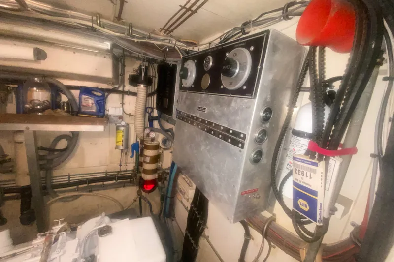 Slide: The Image of Engine room of 1983 Hatteras 53 Motor Yacht with control panel and equipment. - 45