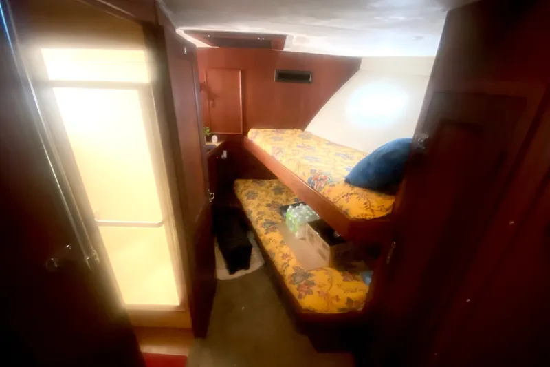 Slide: The Image of Interior cabin of 1983 Hatteras 53 Motor Yacht with bunk beds and wooden finish. - 28