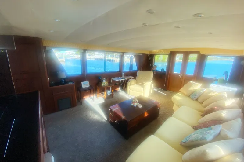 Slide: The Image of Luxurious interior of a 1983 Hatteras 53 Motor Yacht with plush seating and scenic windows. - 17