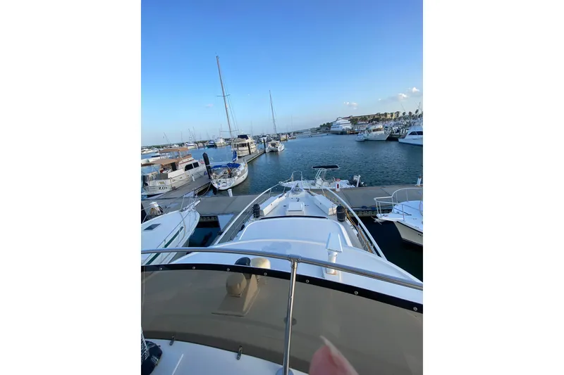 Slide: The Image of 1983 Hatteras 53 Motor Yacht docked at a marina, surrounded by other boats. - 48