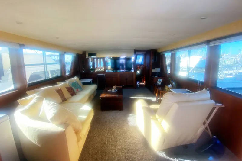 Slide: The Image of Luxurious interior of a 1983 Hatteras 53 Motor Yacht with plush seating and large windows. - 18