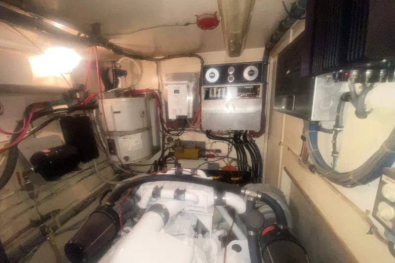 Slide: The Image of Engine room of a 1983 Hatteras 53 Motor Yacht with visible machinery and wiring. - 42