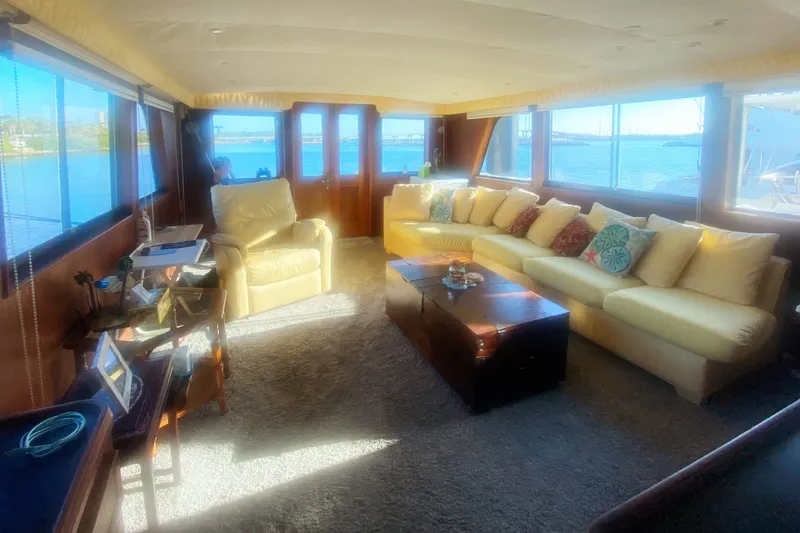 Slide: The Image of Luxurious interior of 1983 Hatteras 53 Motor Yacht with plush seating and scenic views. - 15