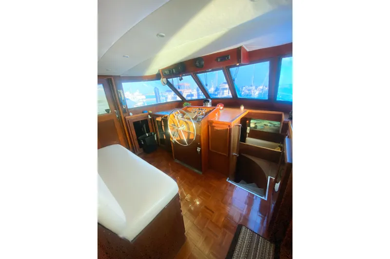 Slide: The Image of 1983 Hatteras 53 Motor Yacht helm with wooden interior and large windows. - 13